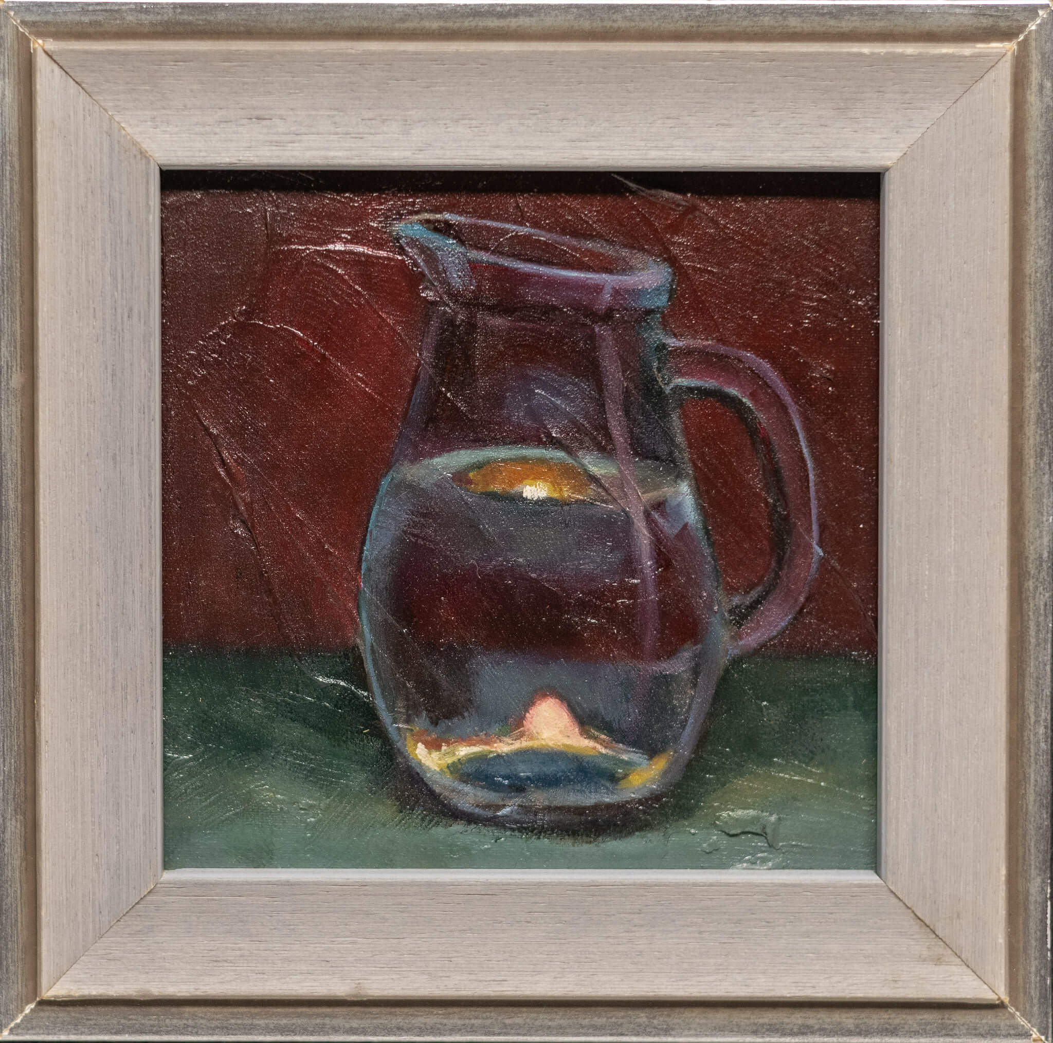 Still life oil painting of a clear glass jug filled with water, reflecting warm fiery orange tones against cool blue hues.