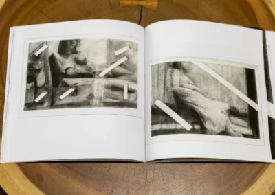 Inner Body open spread with charcoal figure drawings layered with strips of masking tape
