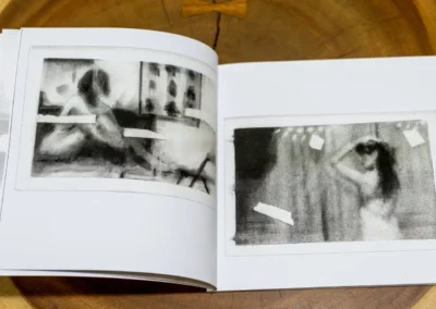 Inner Body open spread with charcoal drawings of a figure by a window and a figure with raised arms